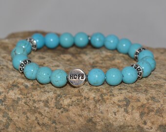 Pulsera Esperanza Turquesa: Joyería elástica de cuentas con detalles de peltre