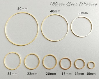 May include: A collection of matte gold-plated circular rings in various sizes, ranging from 10mm to 50mm in diameter. The image displays seven rings, each with a different size clearly labeled in millimeters. The text "Matte-Gold Plating" is visible at the top.
