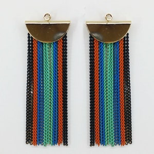 May include: A pair of gold and multi-colored tassel earrings. The earrings feature a gold half-circle top with a dangling tassel of black, orange, blue, and green chains.