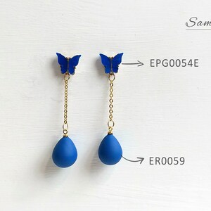 May include: A pair of blue butterfly earrings with gold-colored chains and teardrop-shaped pendants. The earrings are displayed on a white surface. The text "Sample" is in the upper right corner. The product codes are EPG0054E and ER0059.