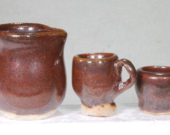 Miniature Deep Red-Brown Hand Thrown Stoneware Pitcher and Two Mugs.