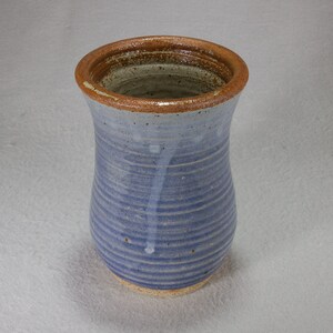 Light blue stoneware drinking glass with brown and beige interior.