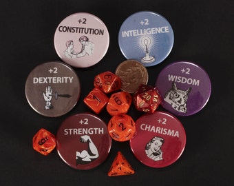 May include: A set of eight round buttons with different colored backgrounds and images. The buttons have text that reads "+2 Constitution", "+2 Intelligence", "+2 Dexterity", "+2 Wisdom", "+2 Strength", "+2 Charisma". There are also six orange dice with black numbers.