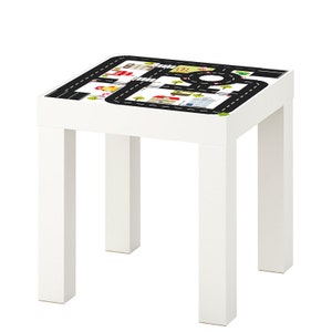 May include: White wooden table with a black and white road map design on the top surface. The table has four legs.