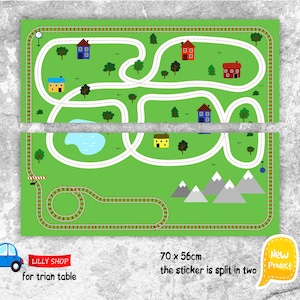 May include: A green play mat with a road and train track design, featuring houses, trees, a lake, and mountains. The mat is split in two and measures 27.5 x 22 inches. A blue car graphic and text "LILLY SHOP for trian table" are included.