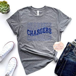 May include: Gray t-shirt with the word "Chargers" repeated three times in blue glitter lettering.