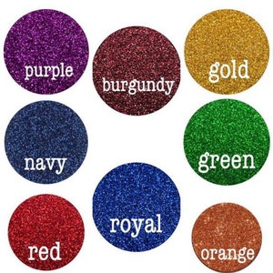 May include: A selection of glitter colors in round containers. The colors are purple, burgundy, gold, green, navy, royal blue, red, and orange.