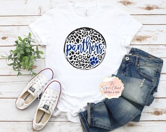 May include: White t-shirt with a blue and black leopard print circle design that says "panthers" in blue glitter lettering. The design also includes a blue paw print.