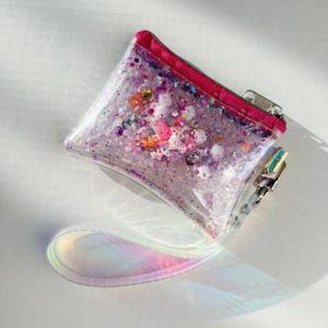 Cartera holográfica de unicornio con correa para la muñeca: bolsa de vinilo de 9 x 13 cm, correa para la muñeca de 16 cm, purpurina y confeti, cartera para fiesta