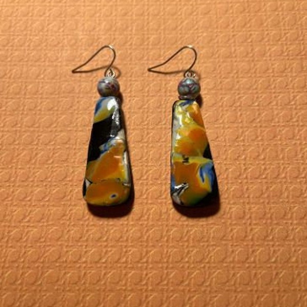 Mokume gane dangly earrings in tan, lack, blue with glass top beads. 2.3" drop length, silver wires.