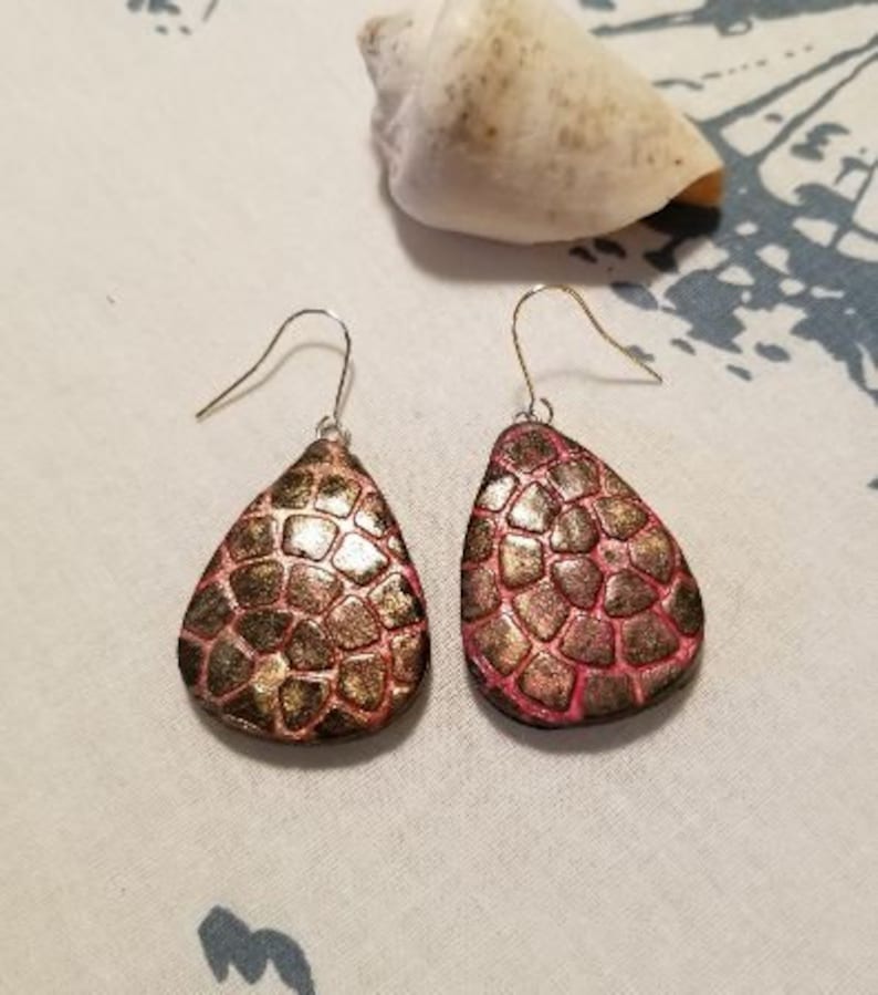 2 drop length Polymer clay rust colored earrings Stamped pattern on front sterling silver ear wiires.