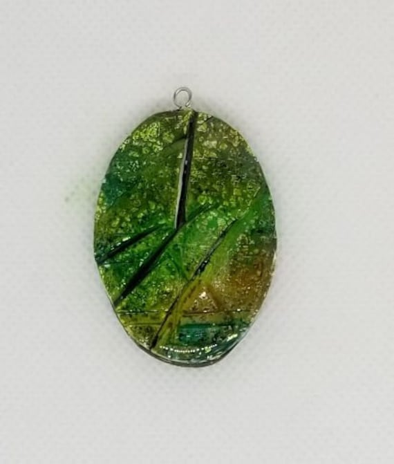 2 long Faux Ammolite pendant in green and silver resin finish.