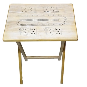 May include: A light-colored wooden folding table with a cribbage board design. The table features a rectangular top with a series of holes and card illustrations. The legs are also made of light-colored wood.