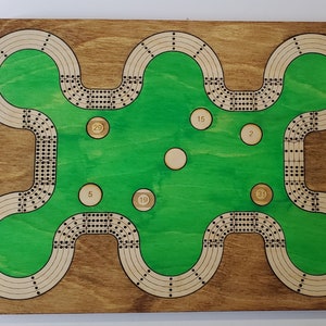 May include: A wooden game board with a green playing surface and numbered circles. The board has a unique shape with multiple curves and loops.