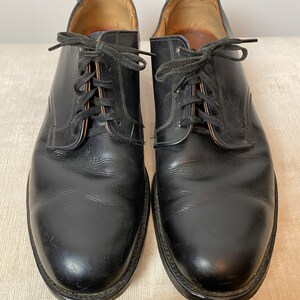 May include: A pair of black leather lace-up shoes with a classic design.