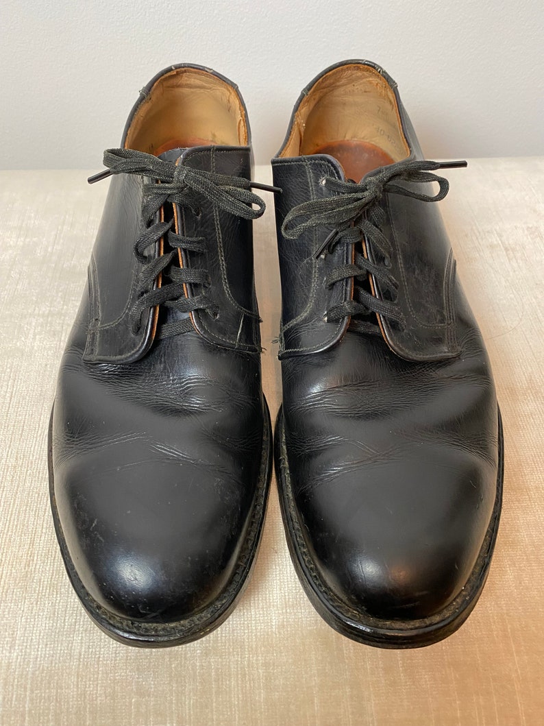 May include: A pair of black leather lace-up shoes with a classic design.