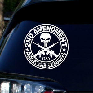 May include: White vinyl decal with a skull and crossbones, two rifles, and the text "2nd Amendment, America's Original Homeland Security, 1789".