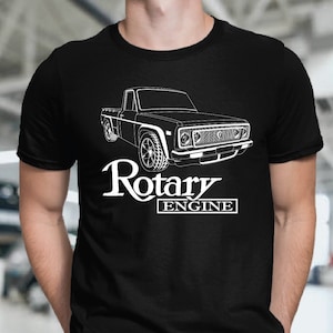 May include: Black t-shirt with a white outline of a pickup truck and the text "Rotary Engine".