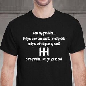 May include: Black t-shirt with white text that reads "Me to my grandkids... Did you know cars used to have 3 pedals and you shifted gears by hand? H Sure grandpa...lets get you to bed"