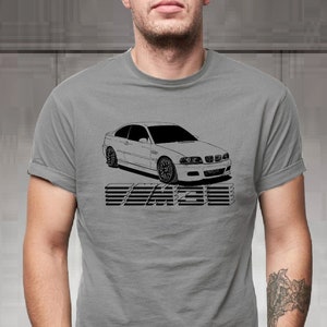 May include: A gray t-shirt with a black outline of a white car and the text "E46 M3" printed on the front.