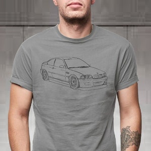 May include: A gray t-shirt with a black outline of a car on the front.