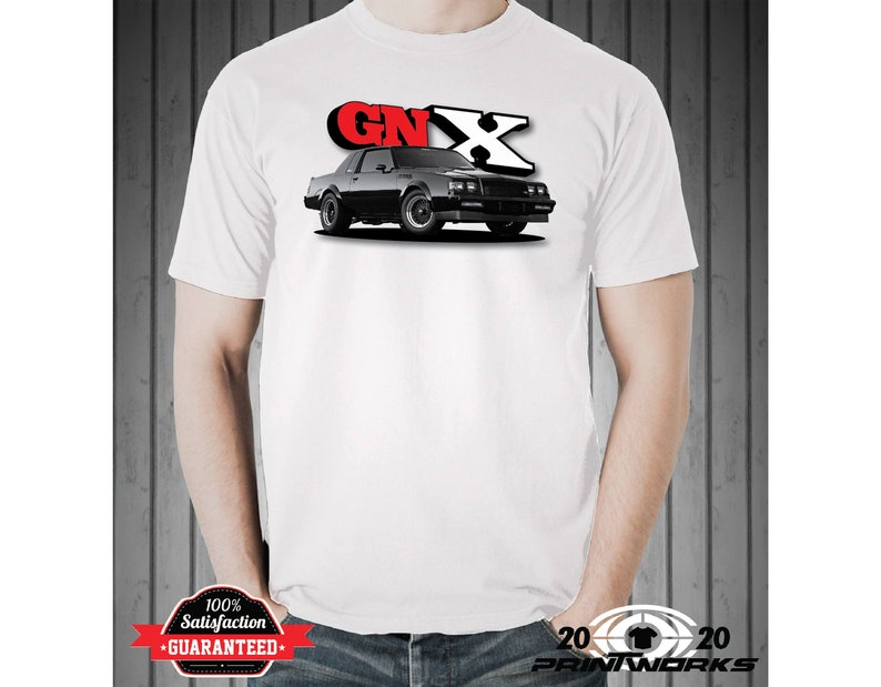 May include: White t-shirt with a black and red graphic of a Buick Grand National GNX car. The car is shown in a side view with the words "GNX" in red and white letters above the car.