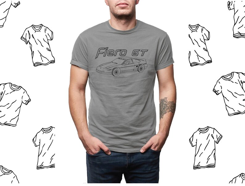 May include: A heather grey t-shirt with a black outline of a car and the text "Fiero GT".