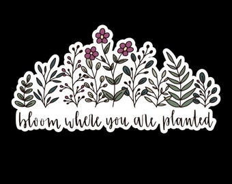 May include: A sticker with a floral design and the text "bloom where you are planted". The flowers are pink and purple, and the leaves are green.