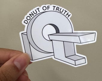 May include: A white sticker with the text "Donut of Truth" and a black and white illustration of a donut-shaped MRI machine.
