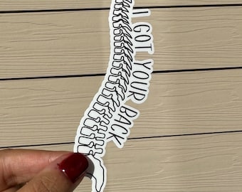 May include: A white sticker with a black outline of a spine and the text "I got your back".