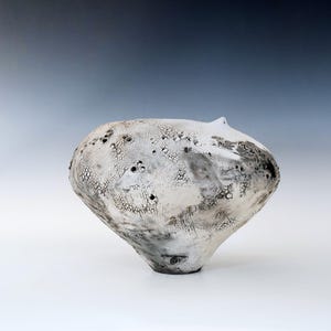 May include: A rustic wooden sign with the text "Welcome to our home" in white lettering. The sign has a distressed finish and a simple, inviting design, ideal for entryway decor.