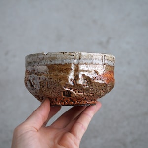 Pode incluir: Um conjunto de três tigelas de cerâmica em tons de azul, verde e branco. As tigelas apresentam um esmalte salpicado e um design simples e moderno. A tigela maior mede aproximadamente 15 cm de diâmetro.