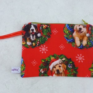 Small zippered bag.  Christmas Dogs Red  print.   approx 18cm x 13cm.   Fully lined and washable.