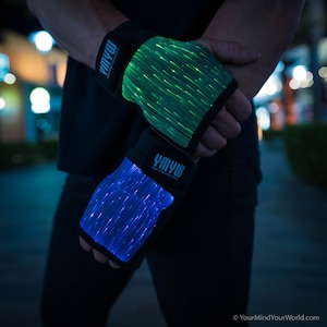 May include: A pair of black fingerless gloves with light-up fibre optic strands. The gloves have the text "YMYW" on the wrist strap, which stands for "Your Mind Your World".