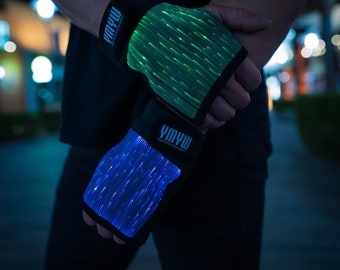 May include: A pair of black fingerless gloves with light-up fiber optic strands. The gloves have the text "YMYW" on the wrist strap, which stands for "Your Mind Your World".