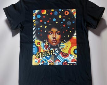 May include: Black t-shirt with a colorful graphic print of a woman with an afro hairstyle and large hoop earrings. The graphic includes geometric shapes and the text "STEEEZEE!"