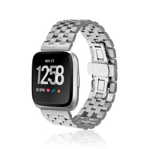 May include: A silver metal watch band with a silver watch face displaying the time 12:58 and the date NOV 23. The watch face also shows a heart rate of 96 BPM and other icons.