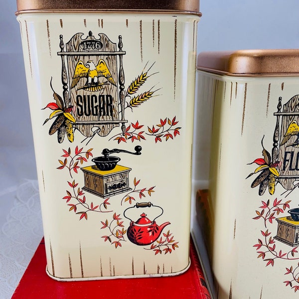 Set of 2 vintage metal kitchen canisters, Bicentennial 1776 design features an eagle, coffee mill, & teapot, made in USA by Chein Co