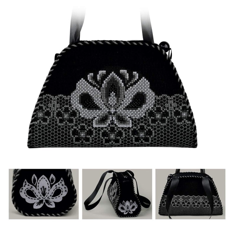 以下が含まれることがあります： 花柄の刺繍が施された黒と白のハンドバッグ。バッグにはトップハンドルとショルダーストラップが付いています。