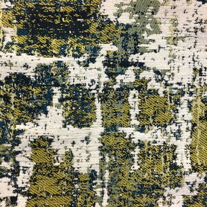 Puede incluir: Tela abstracta con un patr&oacute;n texturizado en tonos de blanco, azul verdoso y dorado.