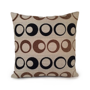 May include: A beige throw pillow with a geometric pattern of brown and black circles.