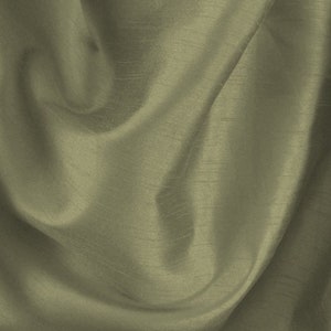 May include: A close-up of a smooth, silky fabric in a muted green colour. The fabric is draped and folded, creating soft, flowing lines.