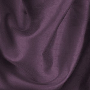 May include: A close-up of a smooth, silky fabric in a deep purple hue. The fabric is draped and folded, creating soft, flowing lines.