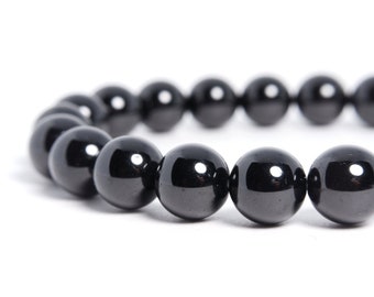 May include: A black beaded bracelet with round, shiny beads.