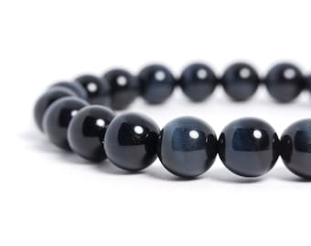 May include: A black beaded bracelet with a dark blue, iridescent sheen. The beads are round and smooth.