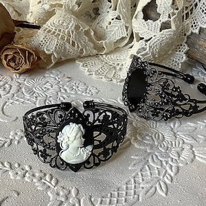 Very ornate "lace carved" black metal enamel adjustable bracelet with detailed black and white "lady portrait" cameo...