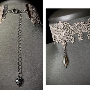 May include: A delicate white lace choker necklace with a silver chain and a pearl pendant. The necklace is adjustable and has a heart-shaped charm at the end of the chain.