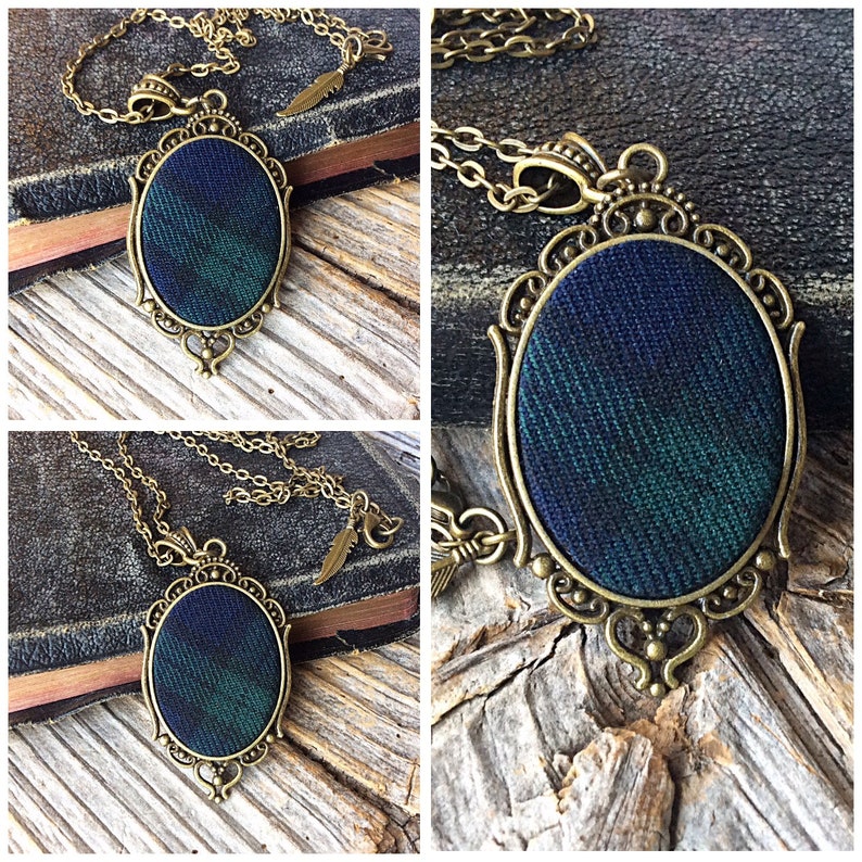 May include: A gold chain necklace with a pendant featuring a green and blue plaid fabric design in an oval frame.