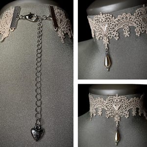 May include: A delicate ivory lace choker necklace with a pearl drop pendant. The necklace has an adjustable chain with a heart-shaped charm.