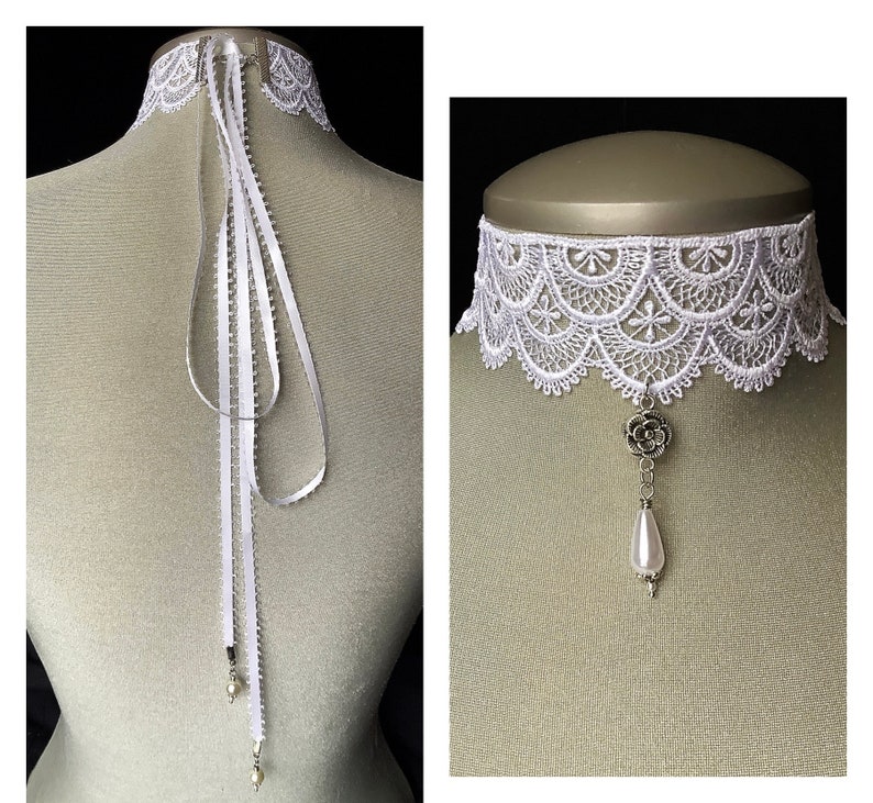 May include: White lace choker necklace with a pearl and flower pendant. The choker is on a white mannequin bust.